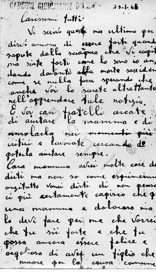 L’immagine riproduce la fotocopia della prima facciata della lettera di Luigi Migliavacca ai suoi cari, scritta il giorno stesso della sua fucilazione. L’originale è scritto su un biglietto delle "Carceri giudiziarie di Torino", com’è scritto nella parte alta del foglio.